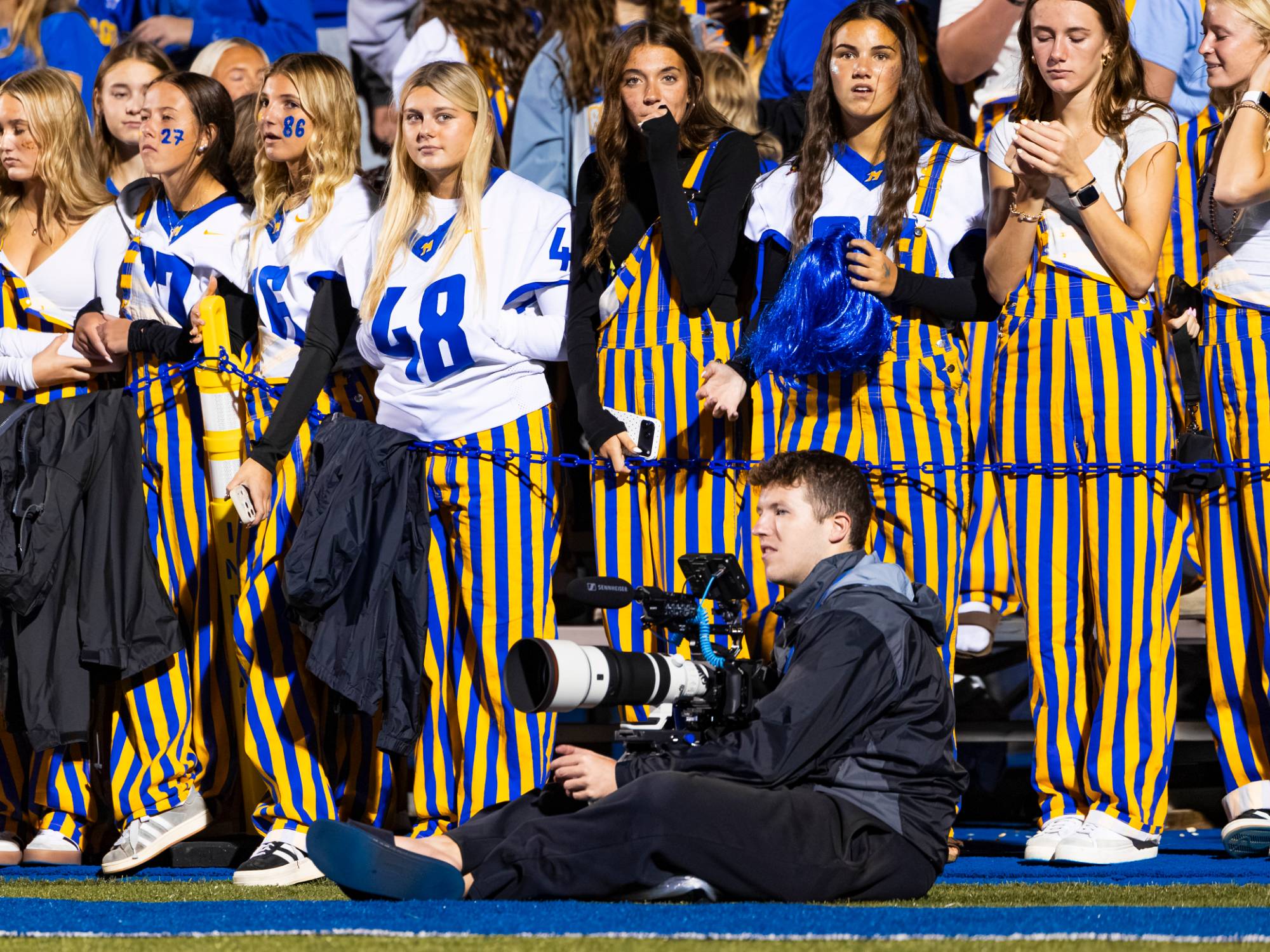 Ethan Jaworski filming from the sideline in front of the student section